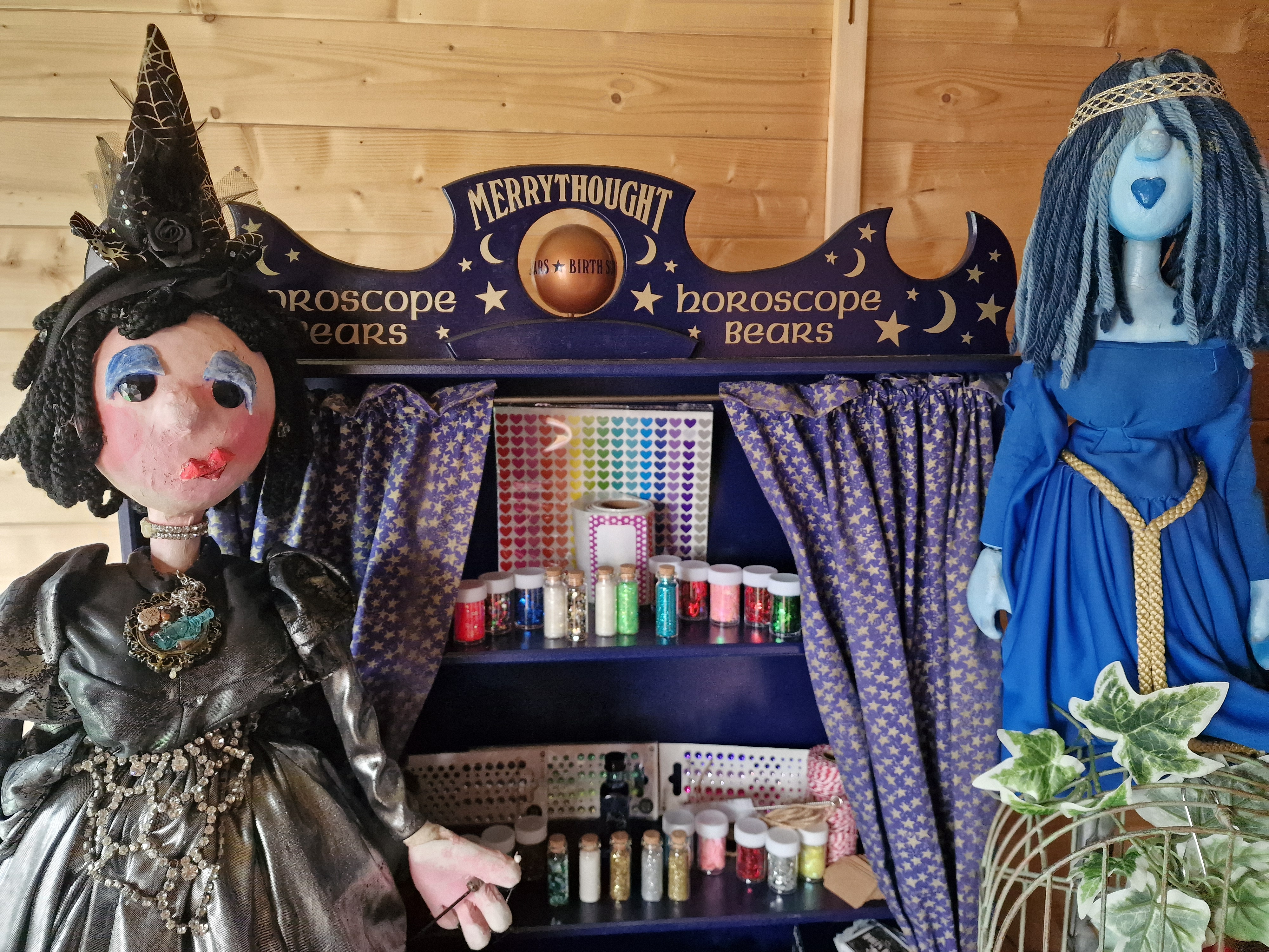 Izzy Wizzy puppet characters beside a magical potion-making booth